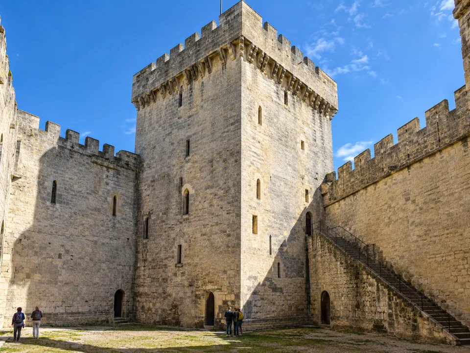 The twelfth-century square keep of the Ch&acirc;teau de Beynac above its cliff